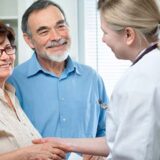 at the doctor's office senior couple visiting a doctor